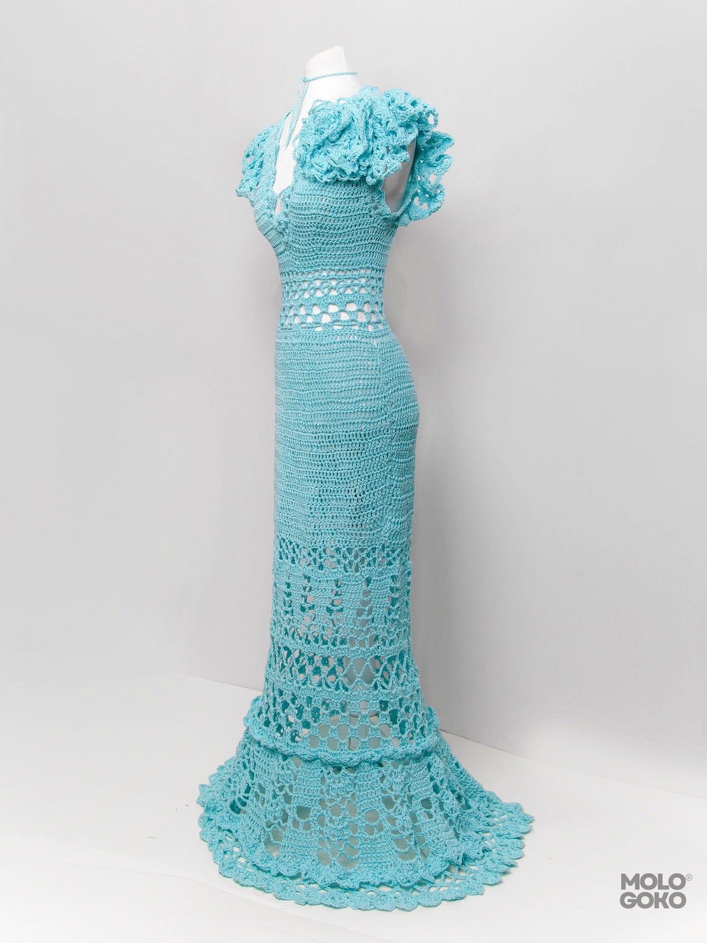 Blossom Crochet Maxi Dress in turquoise with handmade lace pattern, ruffled sleeves and floor-length design on mannequin