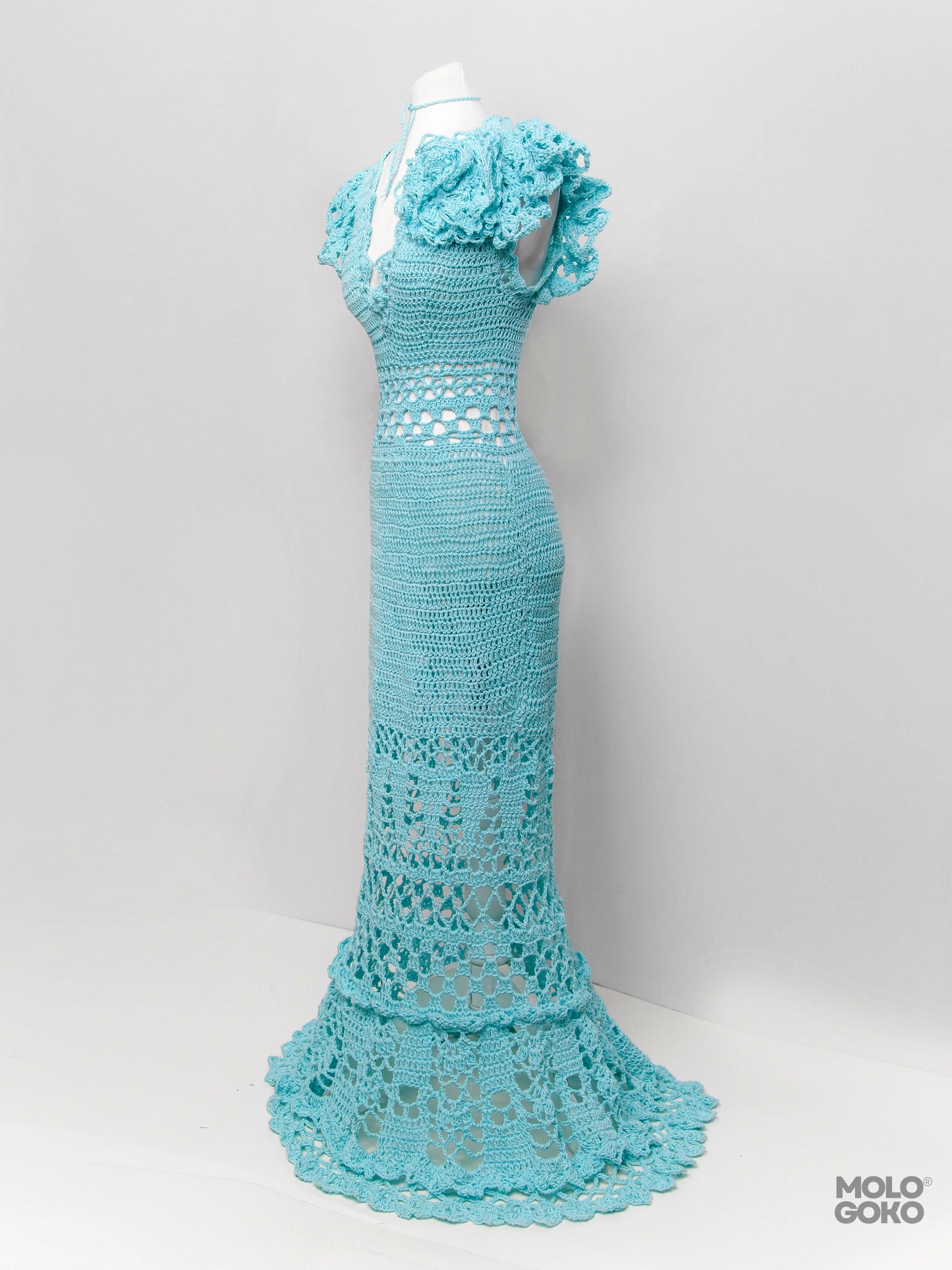 Blossom Crochet Maxi Dress in turquoise with handmade lace pattern, ruffled sleeves and floor-length design on mannequin