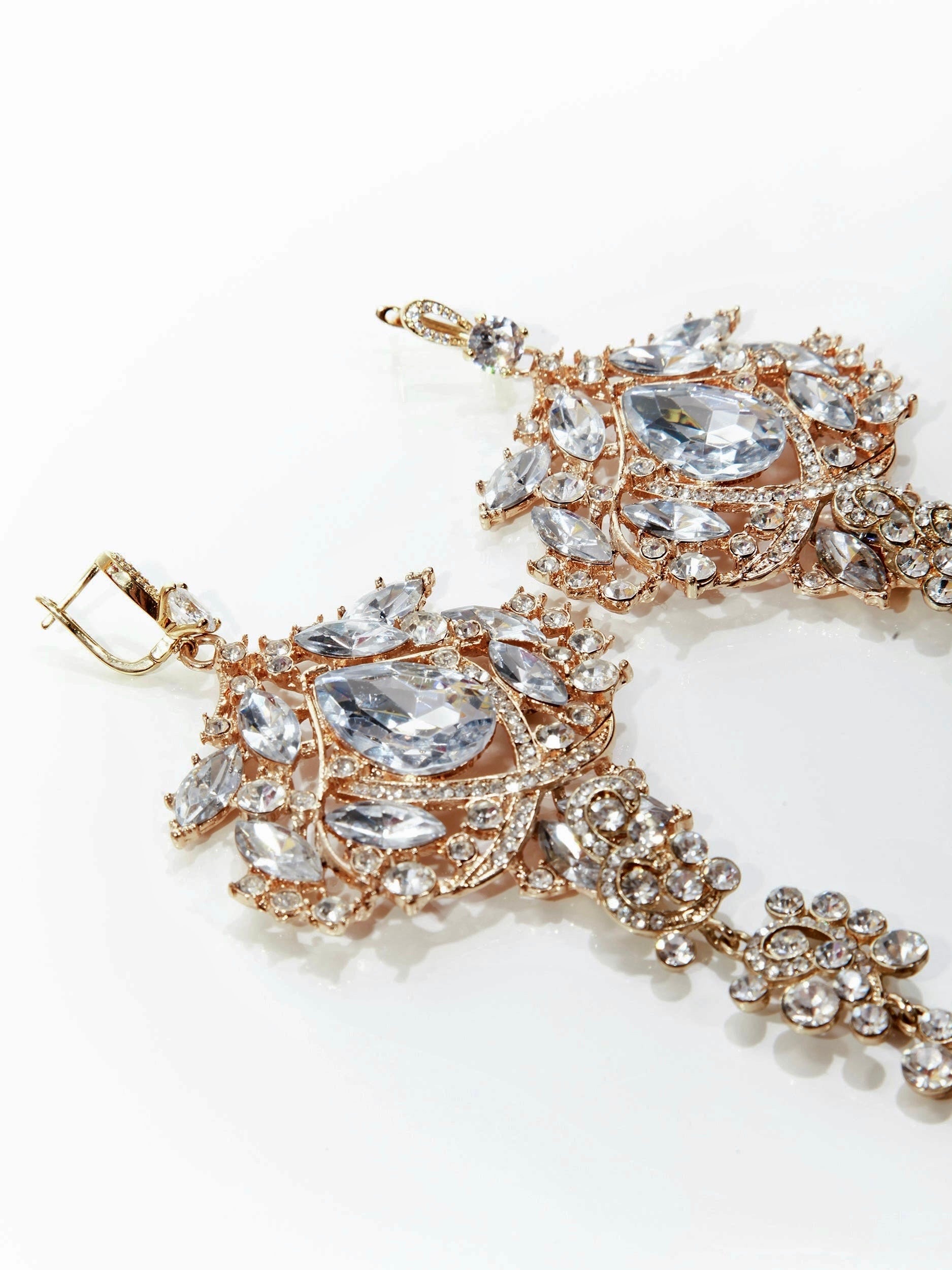 Amily Extra Large Dangle Statement Earrings in rose gold with clear crystals and ornate chandelier design