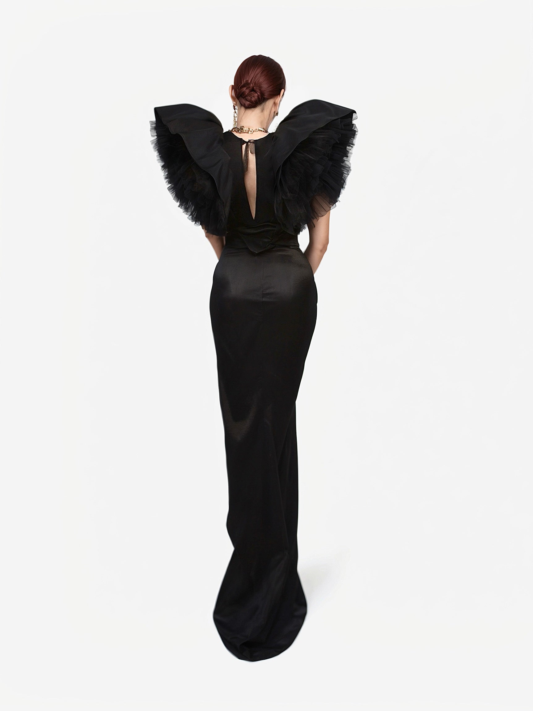 Black and White Monique Gown with dramatic ruffled shoulders and open back, shown from behind in elegant floor-length silhouette