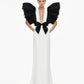 Black and White Monique Gown with dramatic ruffled sleeves, plunging neckline, and black bow detail on white floor-length dress