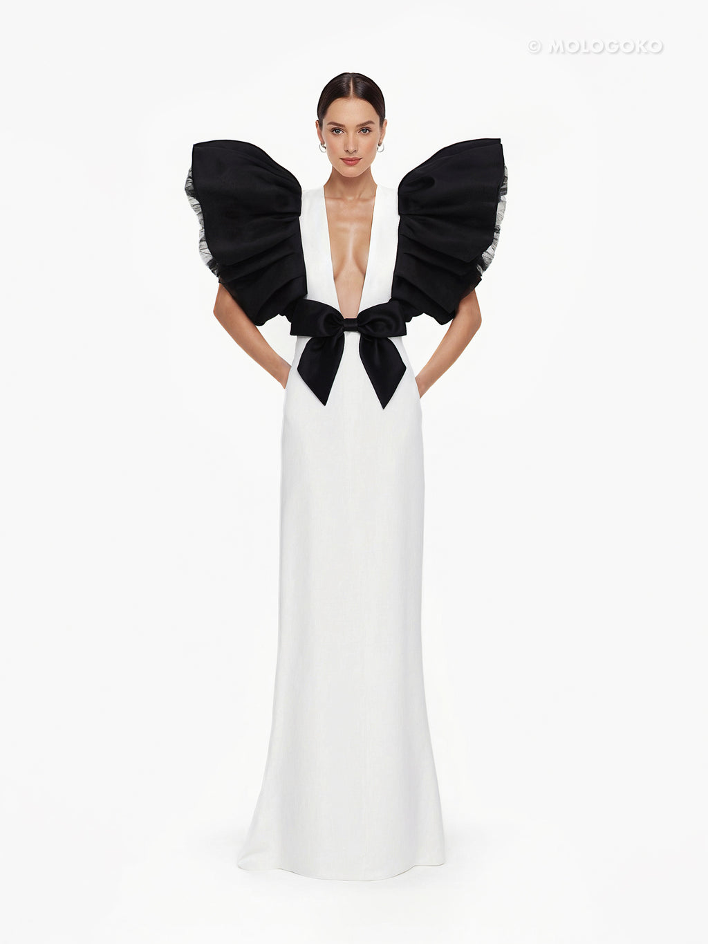 Black and White Monique Gown with dramatic ruffled sleeves, plunging neckline, and black bow detail on white floor-length dress