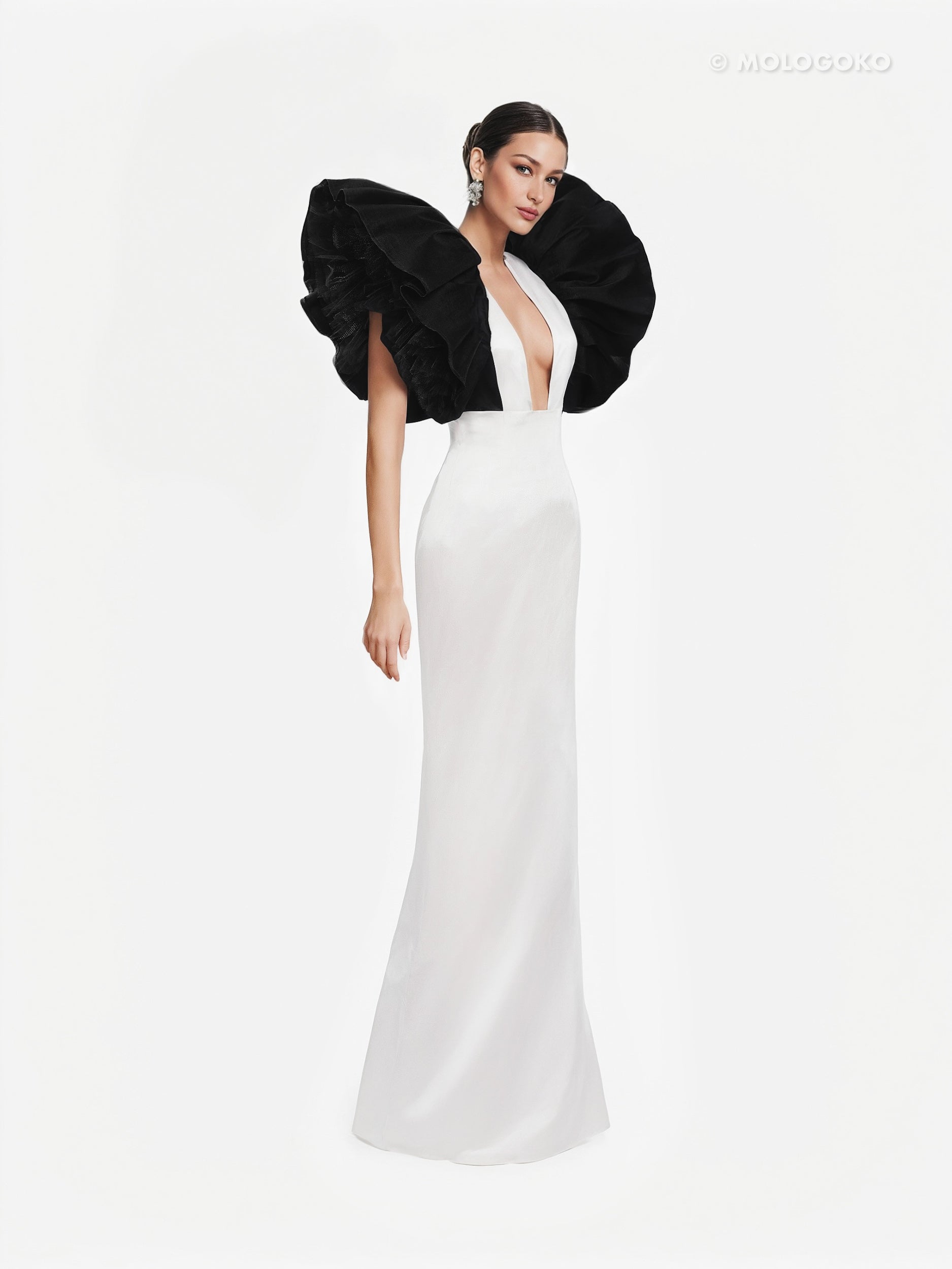 Monique Gown in white with dramatic black ruffled shoulders and plunging neckline, elegant floor-length silhouette