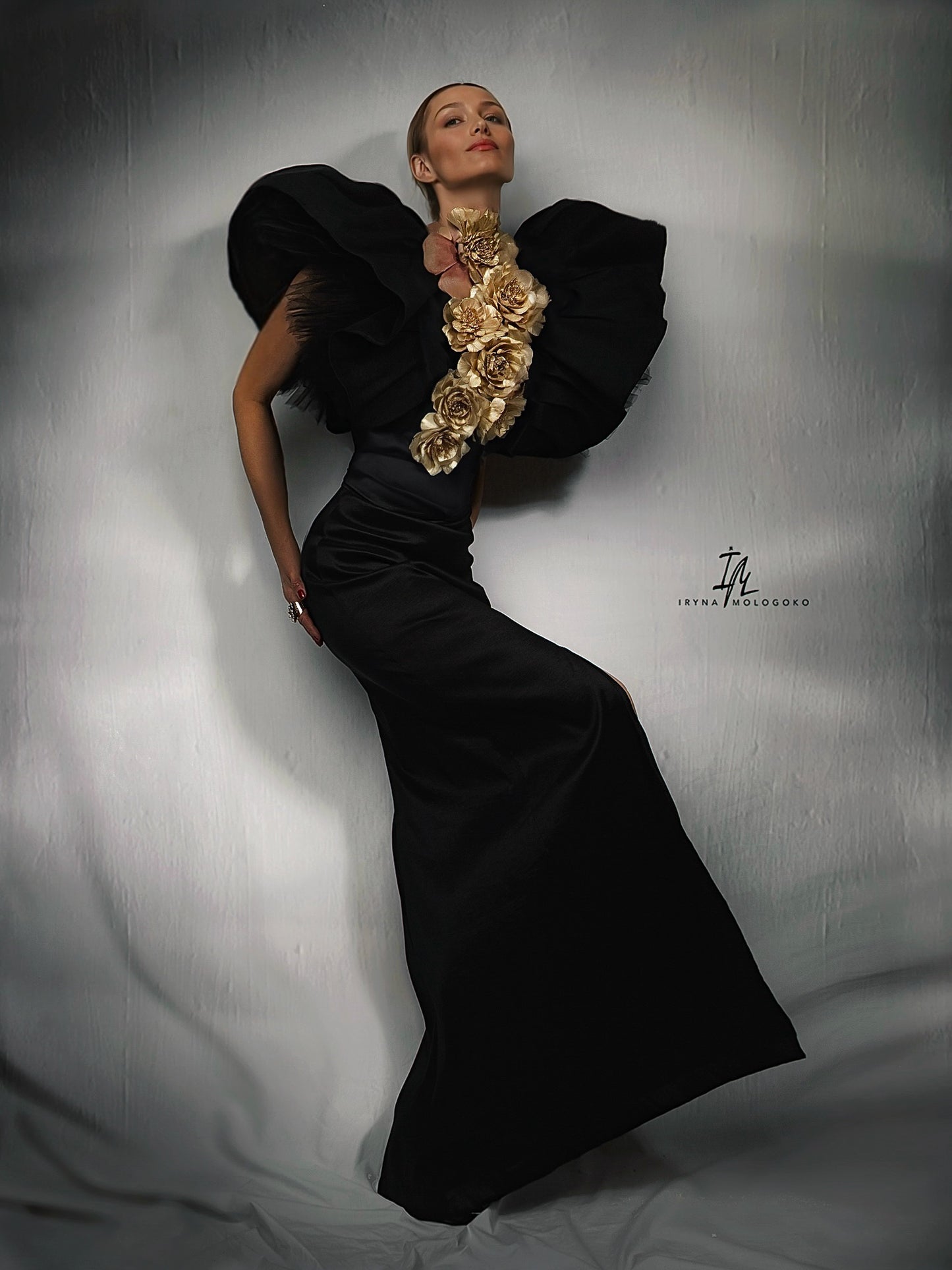 Black and White Monique Gown with dramatic ruffled shoulders and open back, shown from behind in elegant floor-length silhouette