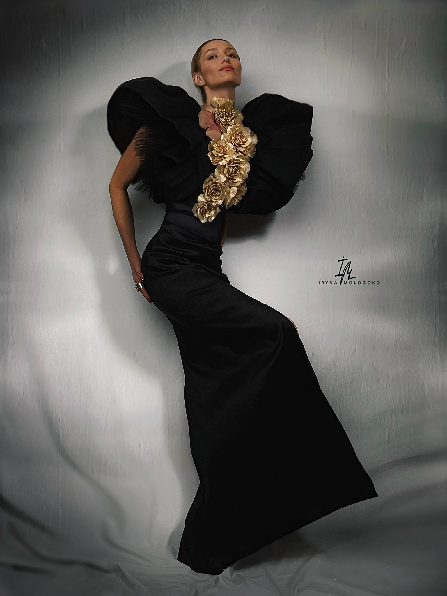 Black and White Monique Gown with dramatic ruffled shoulders and open back, shown from behind in elegant floor-length silhouette
