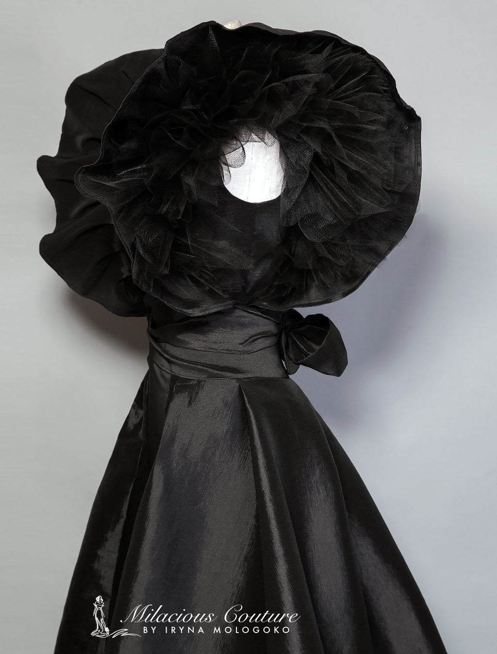 Black and White Monique Gown with dramatic ruffled shoulders and open back, shown from behind in elegant floor-length silhouette